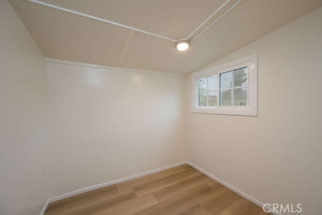 empty room featuring wood finished floors and baseboards