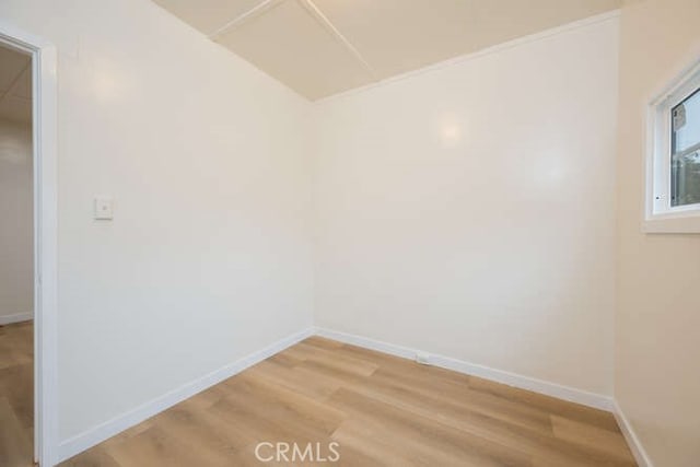 spare room with light wood-style flooring and baseboards