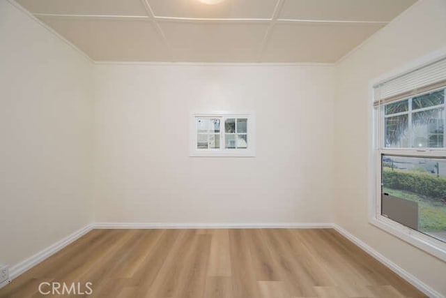 unfurnished room with baseboards and light wood-style floors