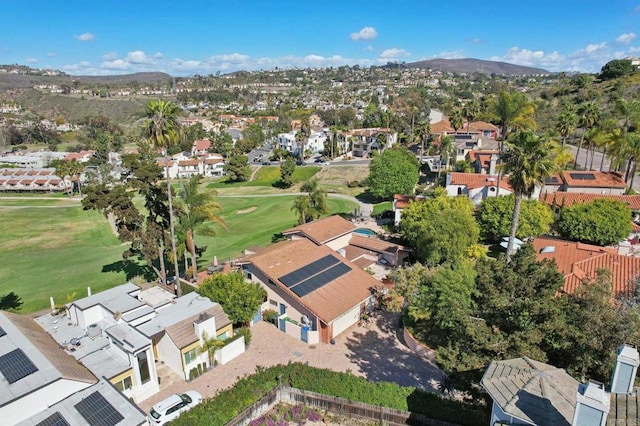 drone / aerial view with a residential view, view of golf course, and a mountain view