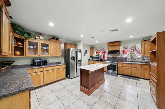 kitchen featuring open shelves, stainless steel appliances, visible vents, light tile patterned flooring, and a sink