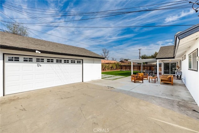 detached garage featuring fence