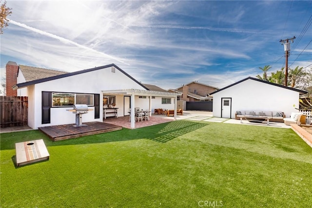 back of house featuring a yard, outdoor lounge area, fence, and a pergola