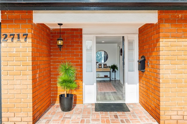 property entrance with brick siding