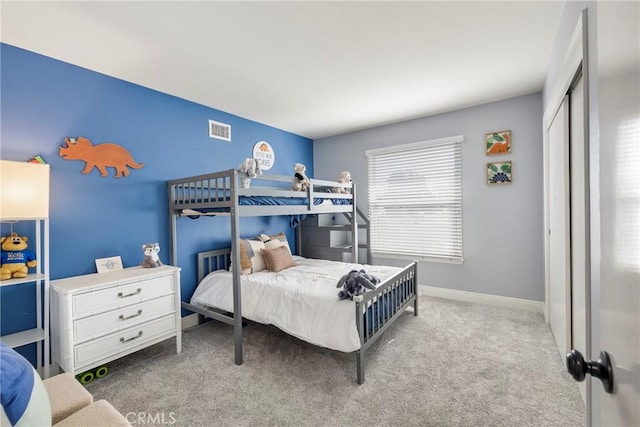 bedroom with baseboards, a closet, visible vents, and carpet flooring