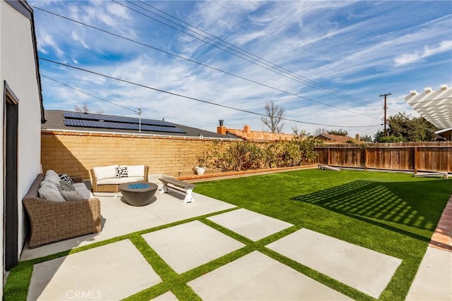 view of yard with a patio area, a fenced backyard, and an outdoor living space with a fire pit