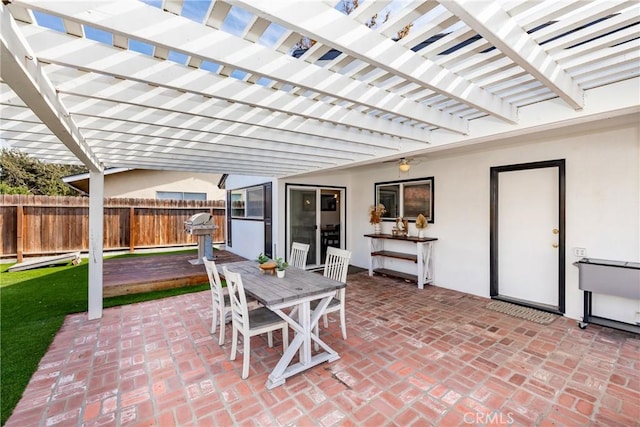 view of patio / terrace featuring fence, a pergola, and outdoor dining space