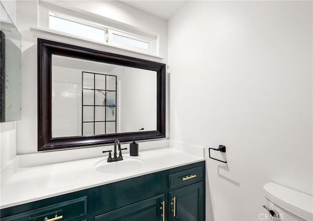 bathroom featuring toilet and vanity