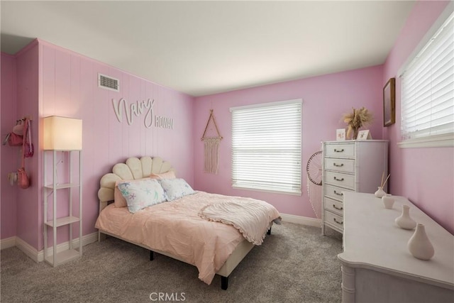 bedroom featuring carpet, multiple windows, visible vents, and baseboards