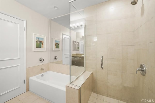 full bathroom featuring tile patterned flooring, a shower stall, and a bath