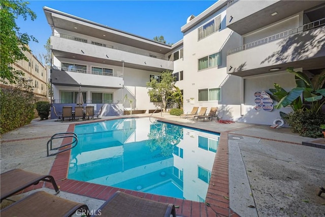 view of swimming pool with a fenced in pool and a patio