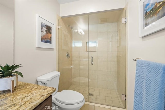 full bathroom featuring a stall shower, vanity, and toilet