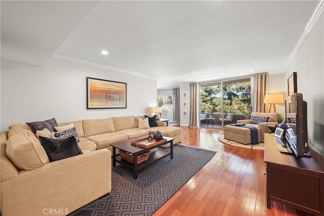 living area with recessed lighting, crown molding, and hardwood / wood-style floors