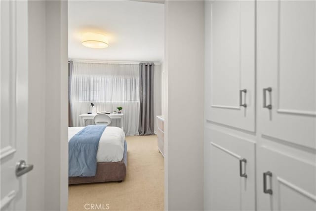 bedroom featuring light colored carpet