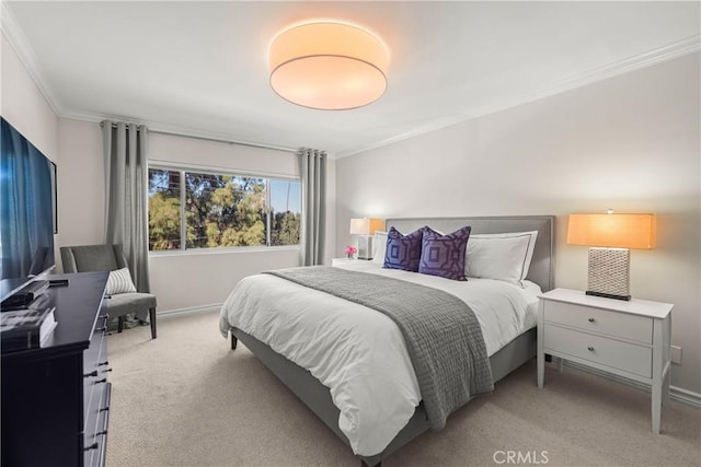 bedroom featuring light colored carpet, crown molding, and baseboards