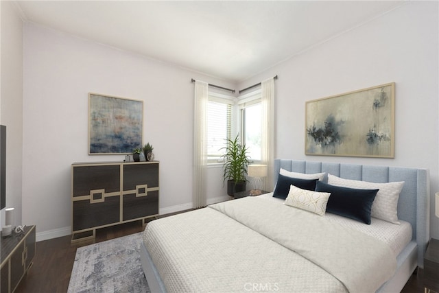 bedroom with baseboards and wood finished floors