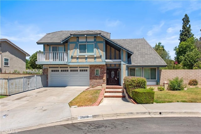 view of front of property with an attached garage, fence, concrete driveway, and brick siding