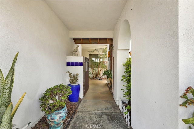 doorway to property featuring stucco siding
