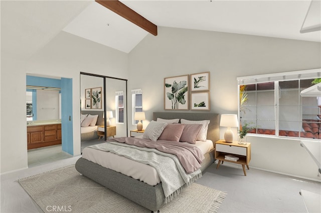 bedroom with baseboards, ensuite bathroom, carpet flooring, beam ceiling, and high vaulted ceiling