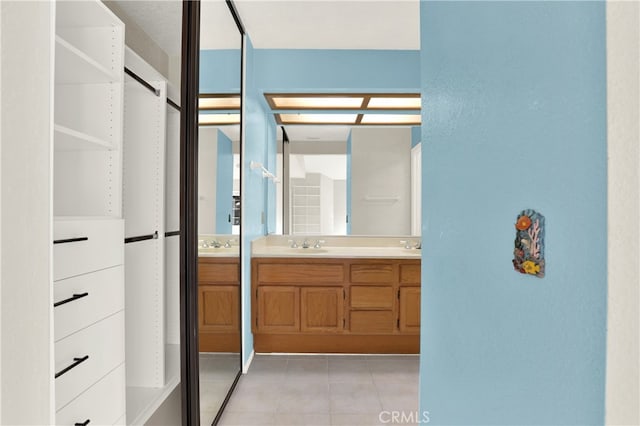 bathroom featuring a sink, tile patterned flooring, and double vanity