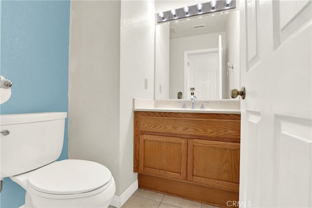 half bathroom featuring visible vents, toilet, tile patterned flooring, and vanity