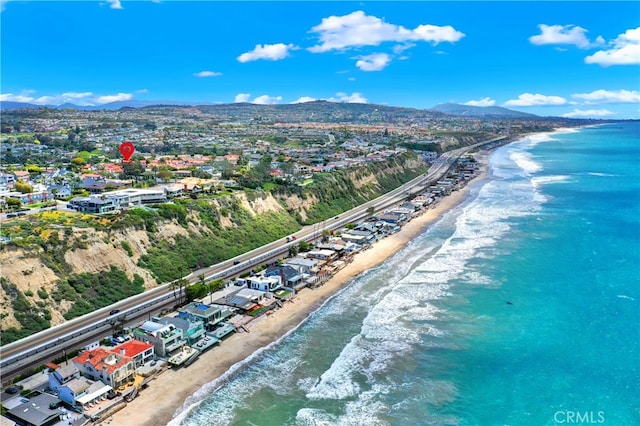 aerial view featuring a view of the beach and a water and mountain view
