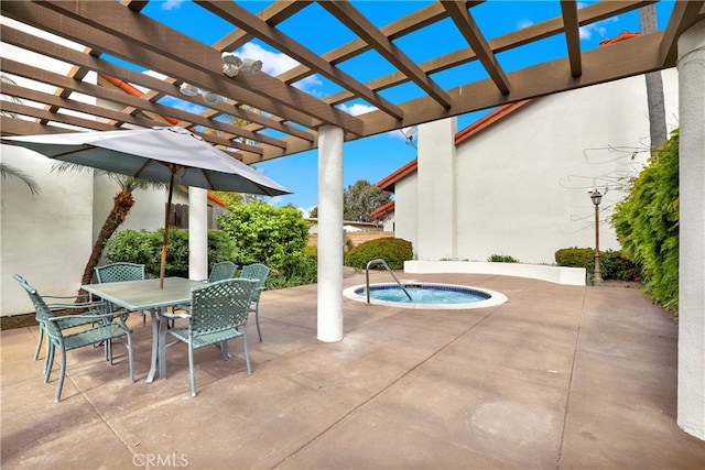 view of patio / terrace with outdoor dining area and an in ground hot tub