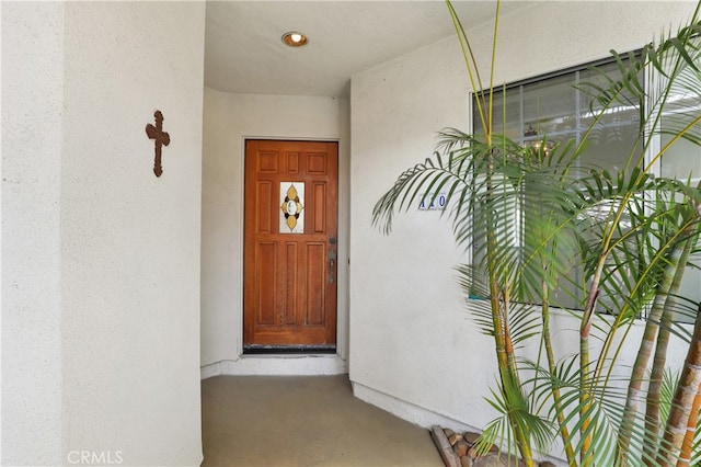 doorway to property with stucco siding