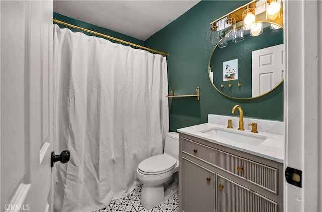 bathroom featuring curtained shower, vanity, and toilet