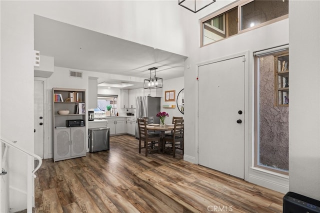 foyer with visible vents and dark wood finished floors