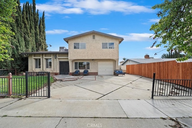 view of front of house with a fenced front yard, stucco siding, driveway, and an attached garage