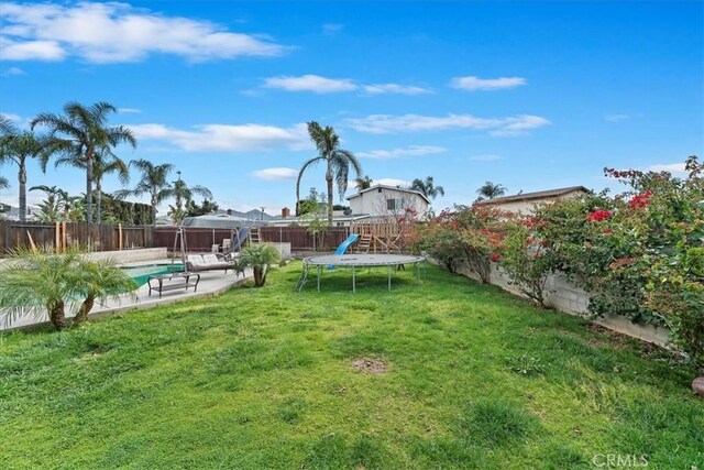 view of yard featuring a fenced in pool, a fenced backyard, and a patio area