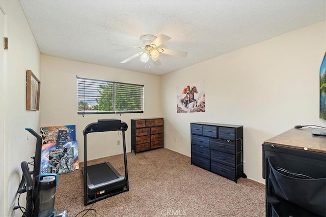 workout room featuring a textured ceiling, ceiling fan, and carpet flooring