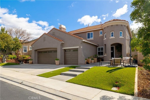 mediterranean / spanish house with stucco siding, a garage, driveway, a tiled roof, and a front lawn