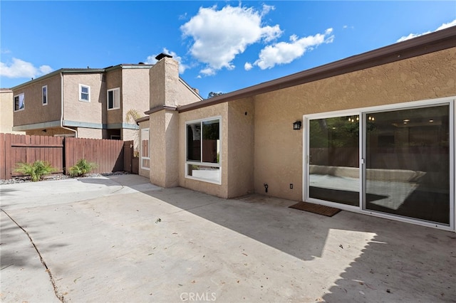 back of property featuring a patio area, fence, and stucco siding