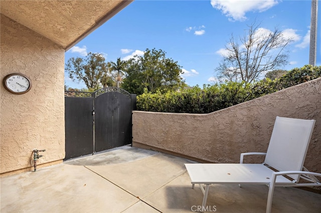 view of patio / terrace featuring a gate and fence