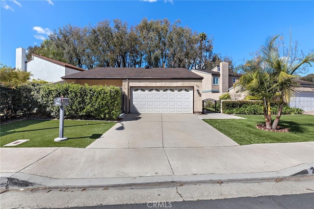 view of front of house featuring a garage, driveway, a front lawn, and fence