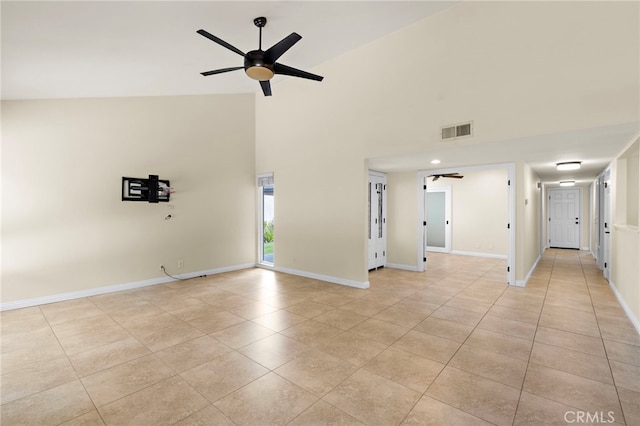 spare room featuring light tile patterned floors, visible vents, and baseboards