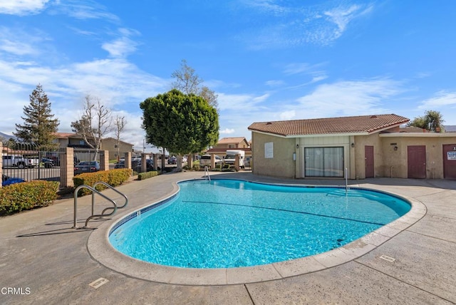 pool featuring a patio and fence