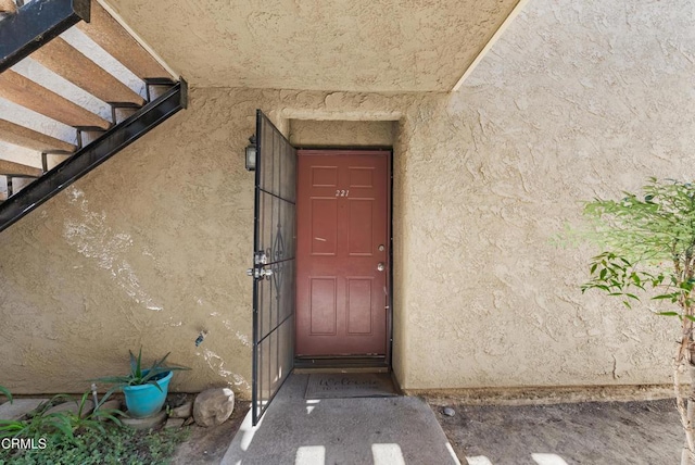 entrance to property with stucco siding