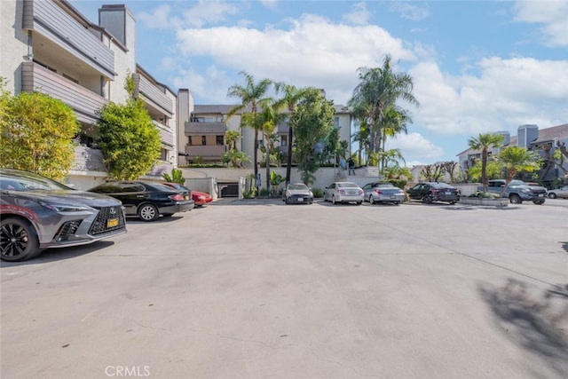 uncovered parking lot with a residential view