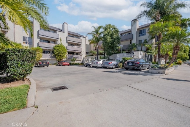 uncovered parking lot featuring a residential view