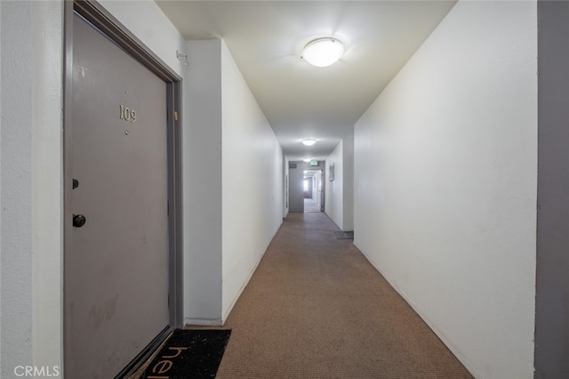 hall with light colored carpet