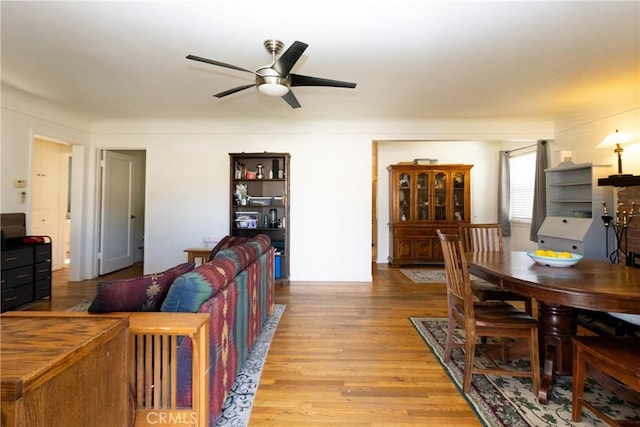 dining space featuring wood finished floors and a ceiling fan