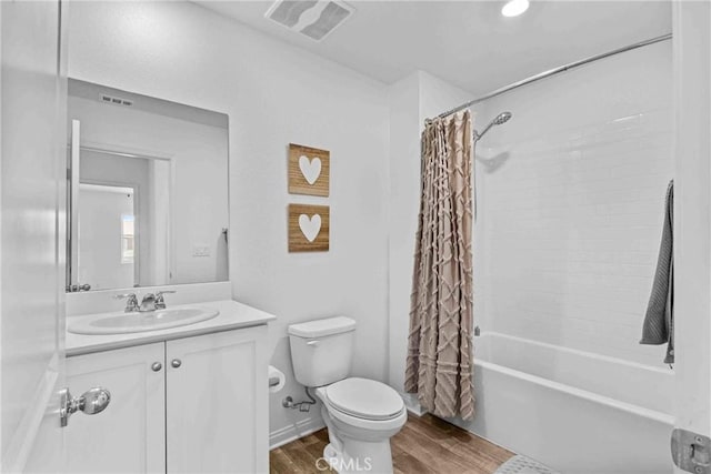 full bathroom with toilet, wood finished floors, visible vents, vanity, and shower / bath combination with curtain