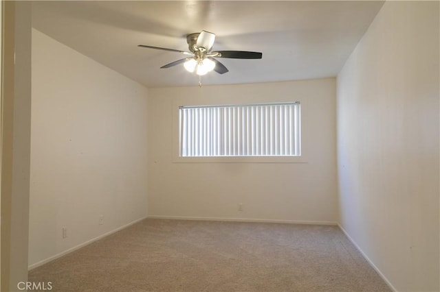 unfurnished room with light carpet, a ceiling fan, and baseboards