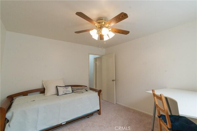 bedroom with a ceiling fan, light colored carpet, and baseboards