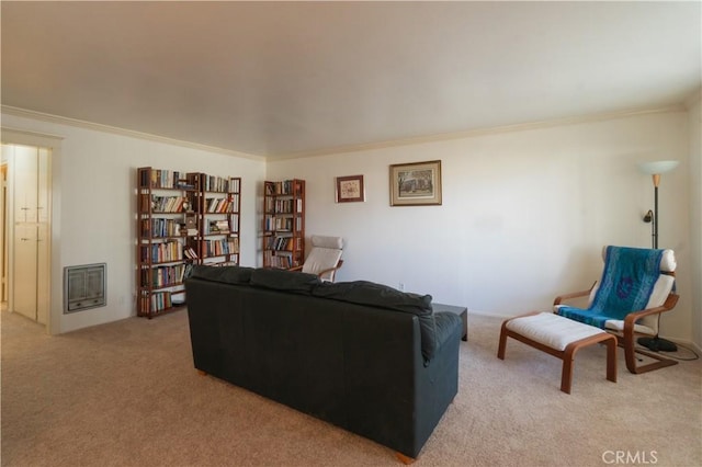 living room with ornamental molding, heating unit, and light colored carpet