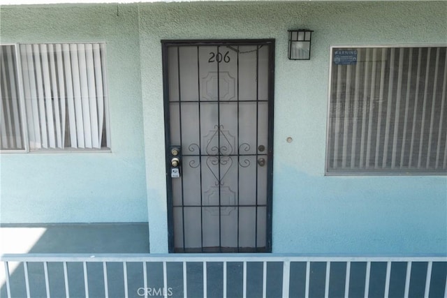 view of exterior entry with stucco siding