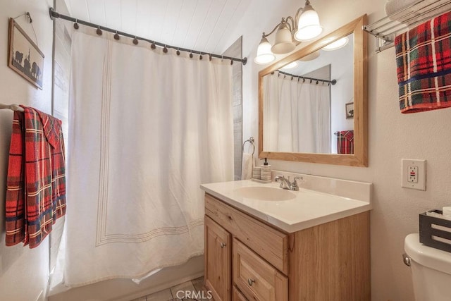 bathroom with shower / bathtub combination with curtain, vanity, and toilet